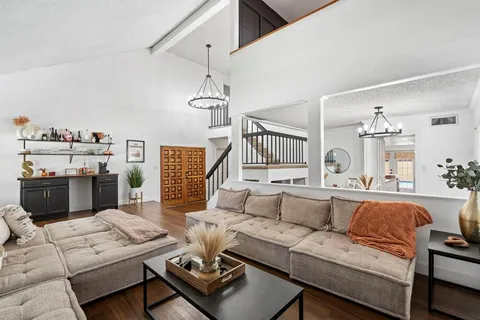 a living room with furniture fireplace and a flat screen tv