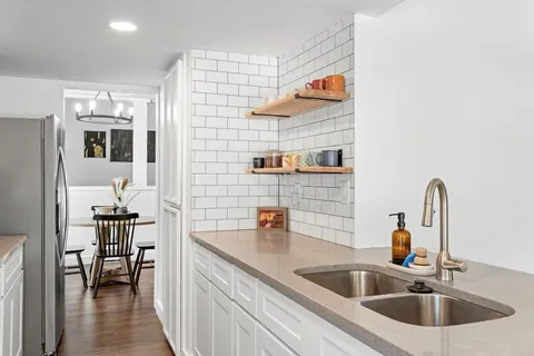 a kitchen with a sink and a refrigerator