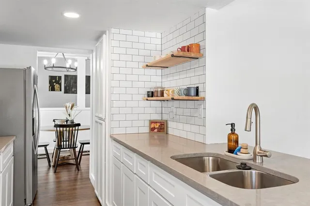a kitchen with a sink and a refrigerator