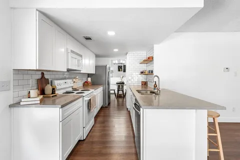 a kitchen with stainless steel appliances a sink stove and refrigerator