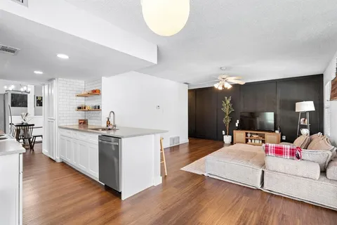 a view of a backyard with a barbeque grill and a lake view