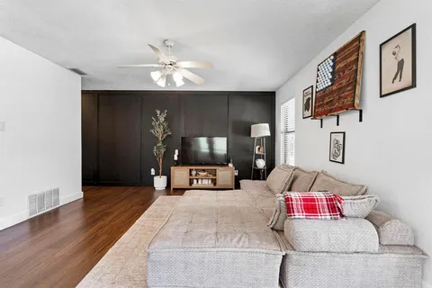 a large white kitchen with cabinets a sink and a stove