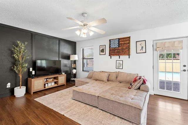 a living room with furniture and a wooden floor