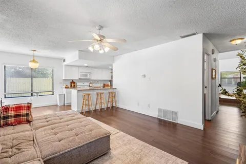a living room with fireplace furniture and a wooden floor