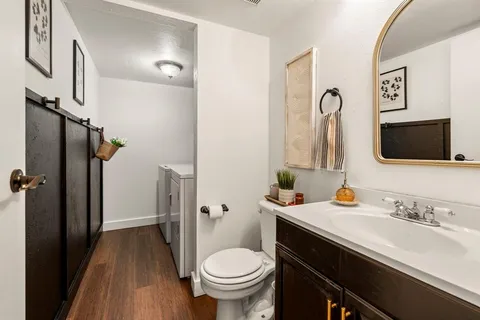 a living room with kitchen island furniture and a chandelier