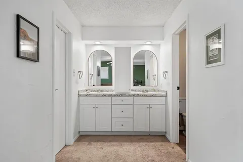 a bedroom with a bed tv and a flat screen tv