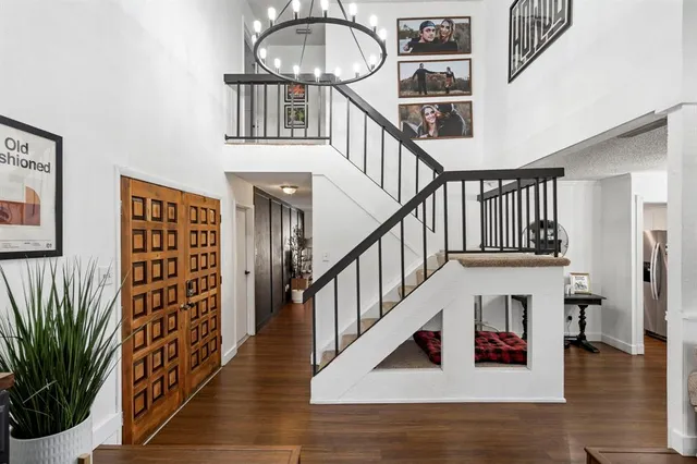 a view of entryway and hall with wooden floor