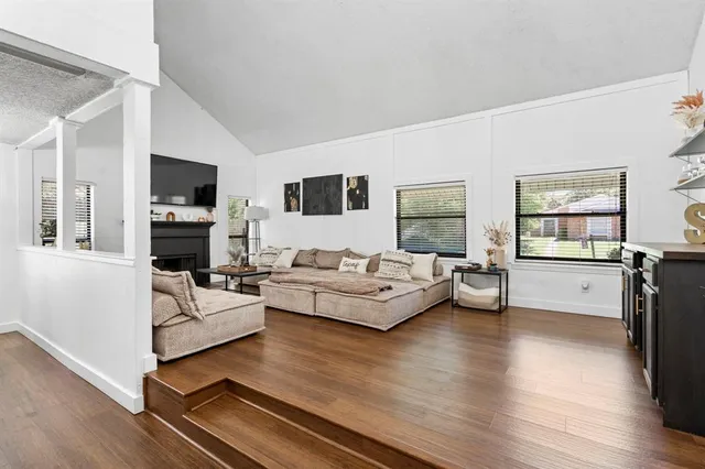 a living room with furniture flat screen tv and a fireplace
