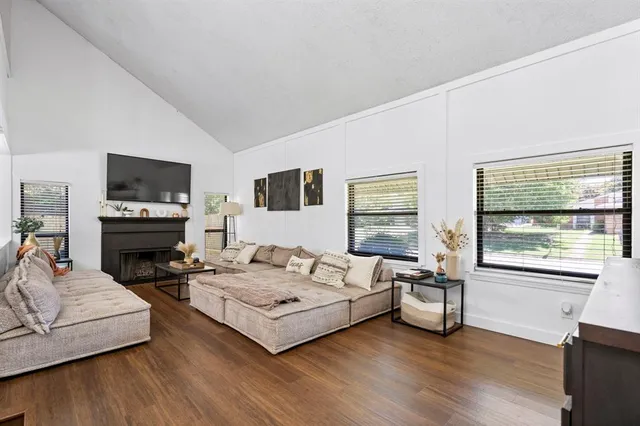a living room with furniture flat screen tv and a fireplace
