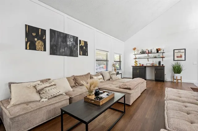 a living room with furniture and wooden floor