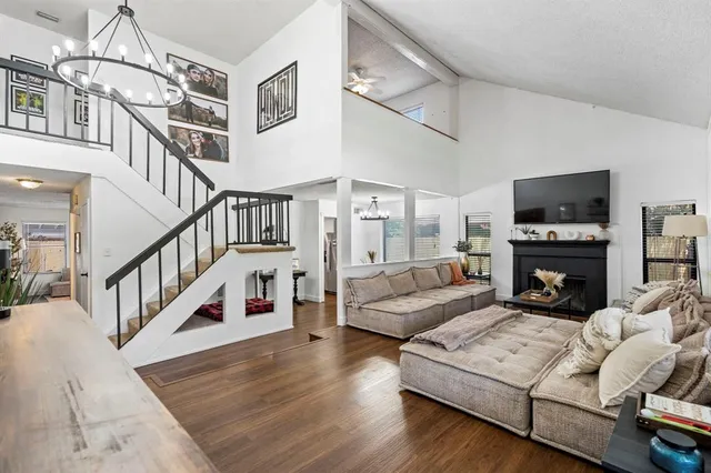 a living room with furniture a fireplace and a flat screen tv