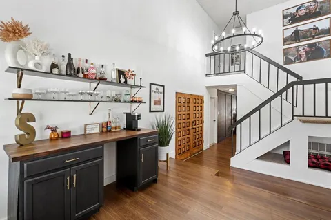 a kitchen with sink cabinets and wooden floor