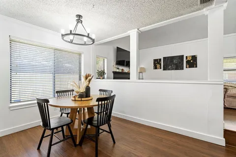 a view of a dining room with furniture window and wooden floor