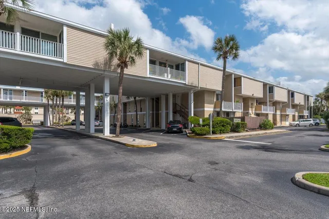 a view of a building with a garden and pathway