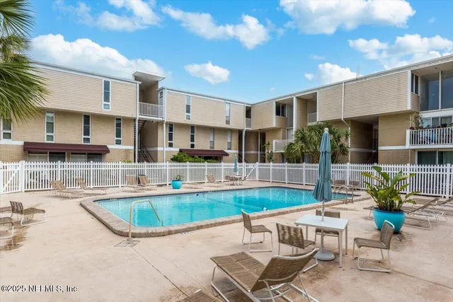 a view of a swimming pool with outdoor seating