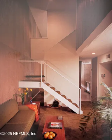 a view of entryway bedroom and hall with wooden floor