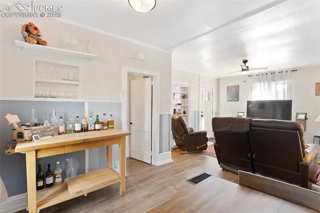 a view of a hallway with entryway and wooden floor