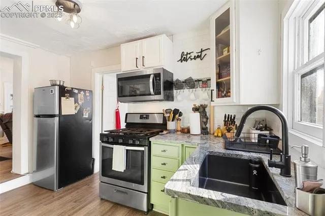 a bathroom with a stove a sink and a mirror