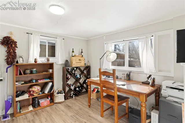 a view of a workspace with furniture and bathroom view