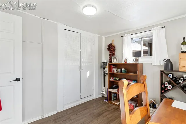 a view of a patio with a table and chairs under an umbrella