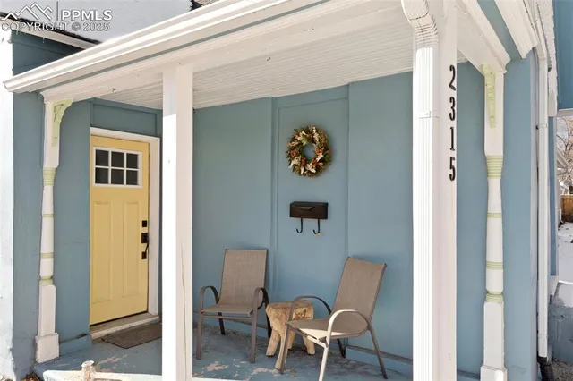 a bathroom with a toilet and a painting on the wall