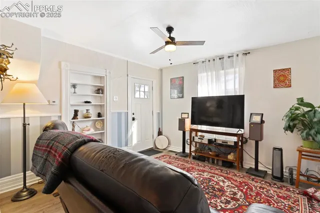 a view of a workspace with furniture and wooden floor