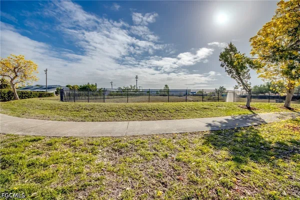a swimming pool with outdoor seating and garden