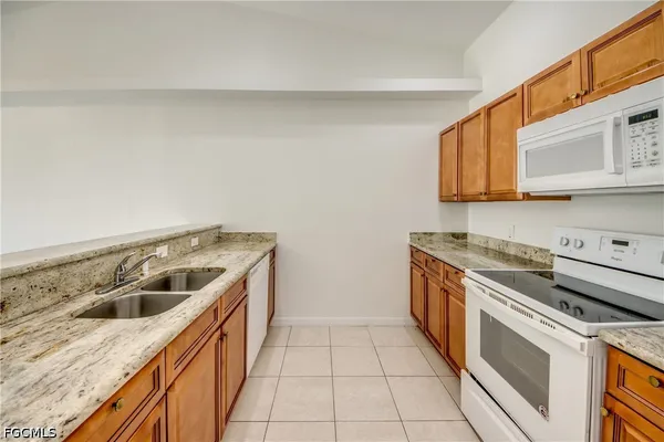 a kitchen with a sink and a stove top oven