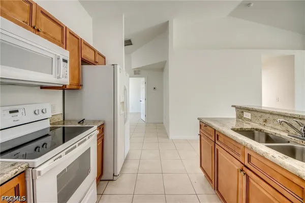 a kitchen that has a sink and a stove