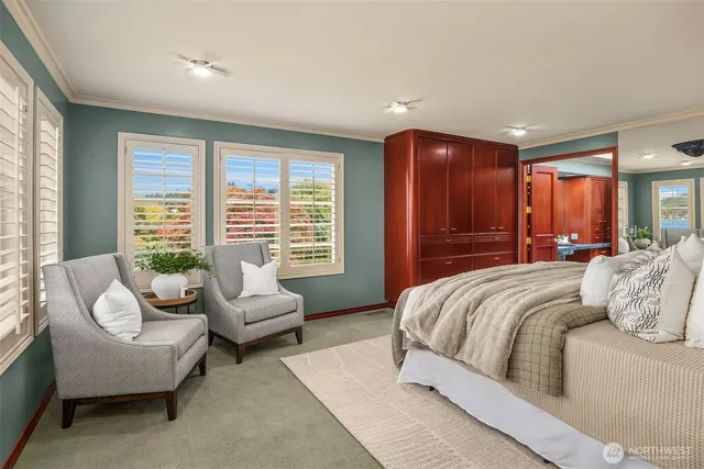 a bedroom with a bed and glass window
