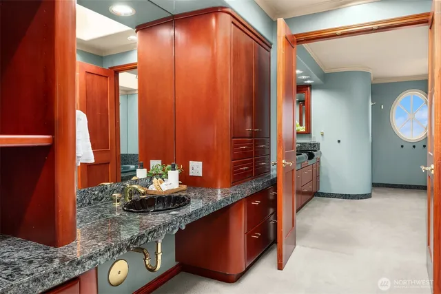 a kitchen with stainless steel appliances granite countertop a sink a stove and a wooden cabinets