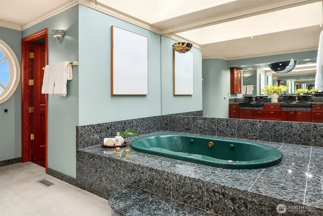 a bathroom with a tub sink and mirror