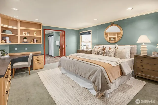 a bedroom with a bed and a lamp on dresser