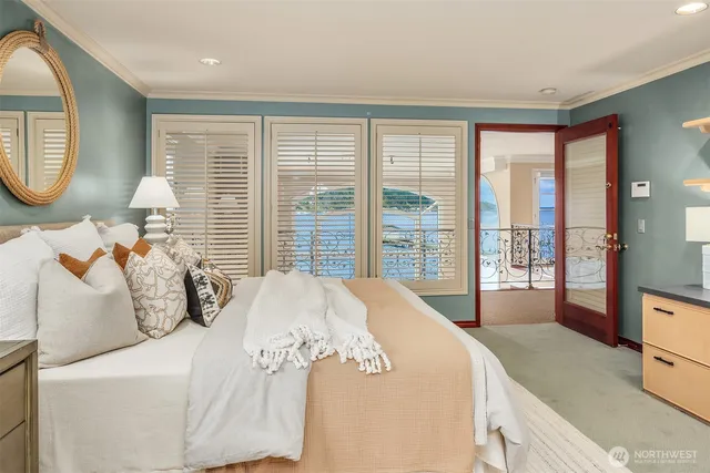 a bedroom with a large bed and a large window