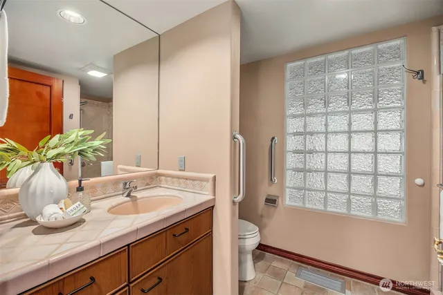 a bathroom with a granite countertop sink and a mirror