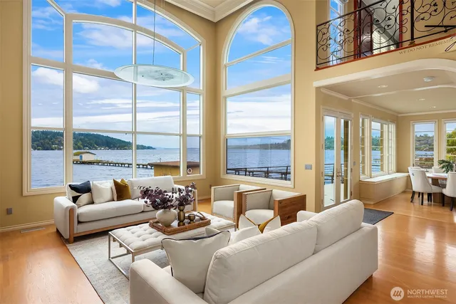 a living room with furniture and floor to ceiling windows