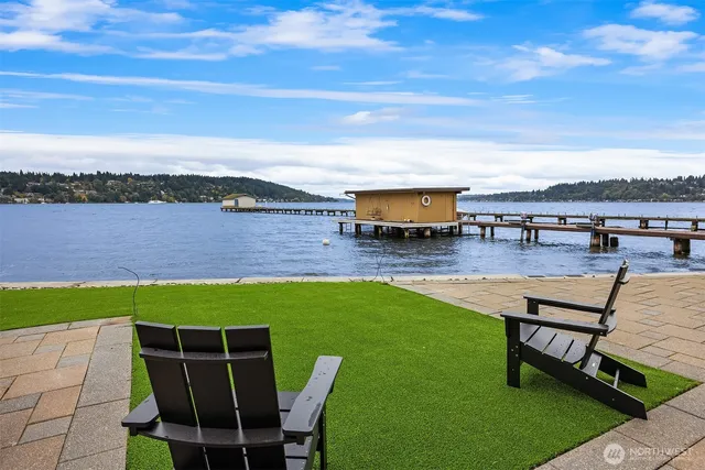 a swimming pool with outdoor seating and city view