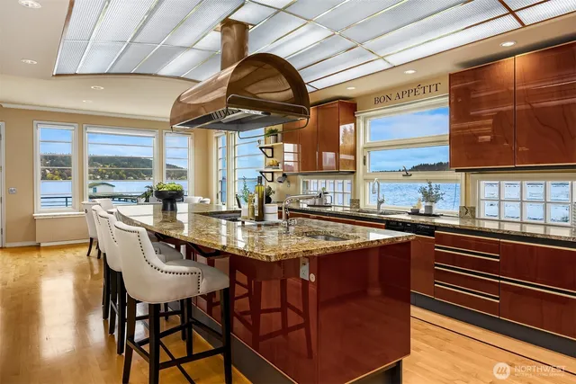 a kitchen with stainless steel appliances granite countertop a sink and wooden cabinets