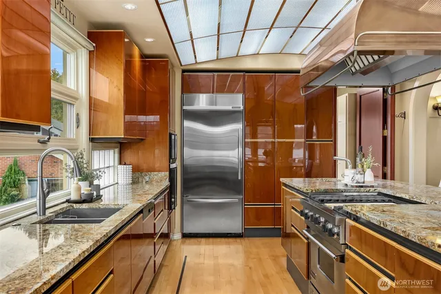 a kitchen with stainless steel appliances granite countertop a sink and a counter space