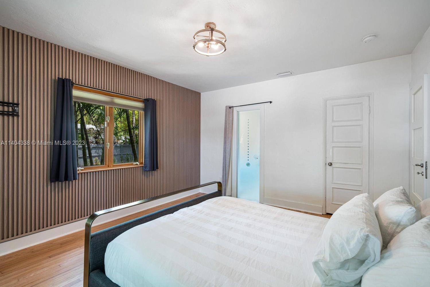 2500 Flamingo Drive Miami Beach, FL 33140 - Photo 12 of 27 a bedroom with a bed and a window