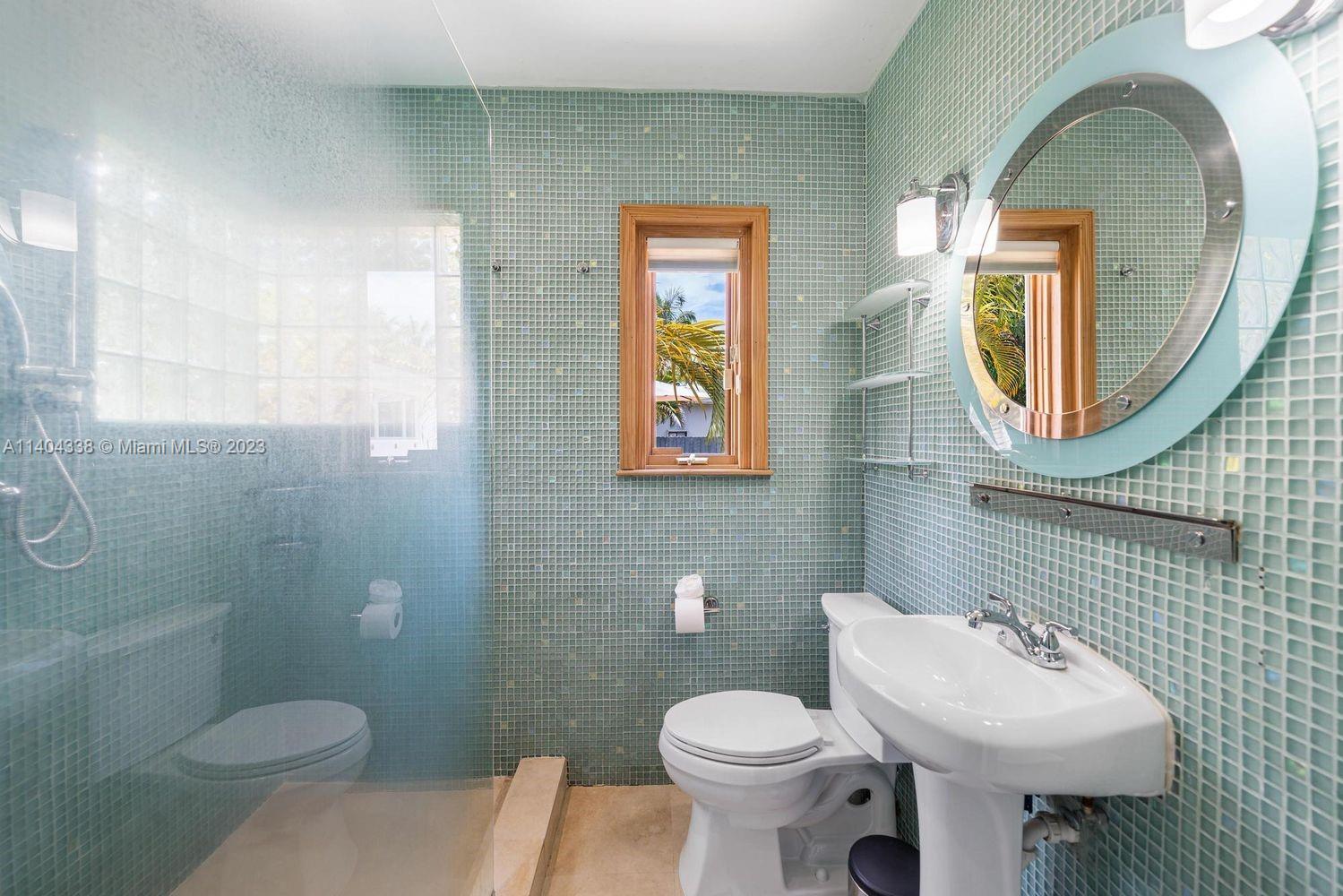 2500 Flamingo Drive Miami Beach, FL 33140 - Photo 13 of 27 a bathroom with a toilet sink and mirror