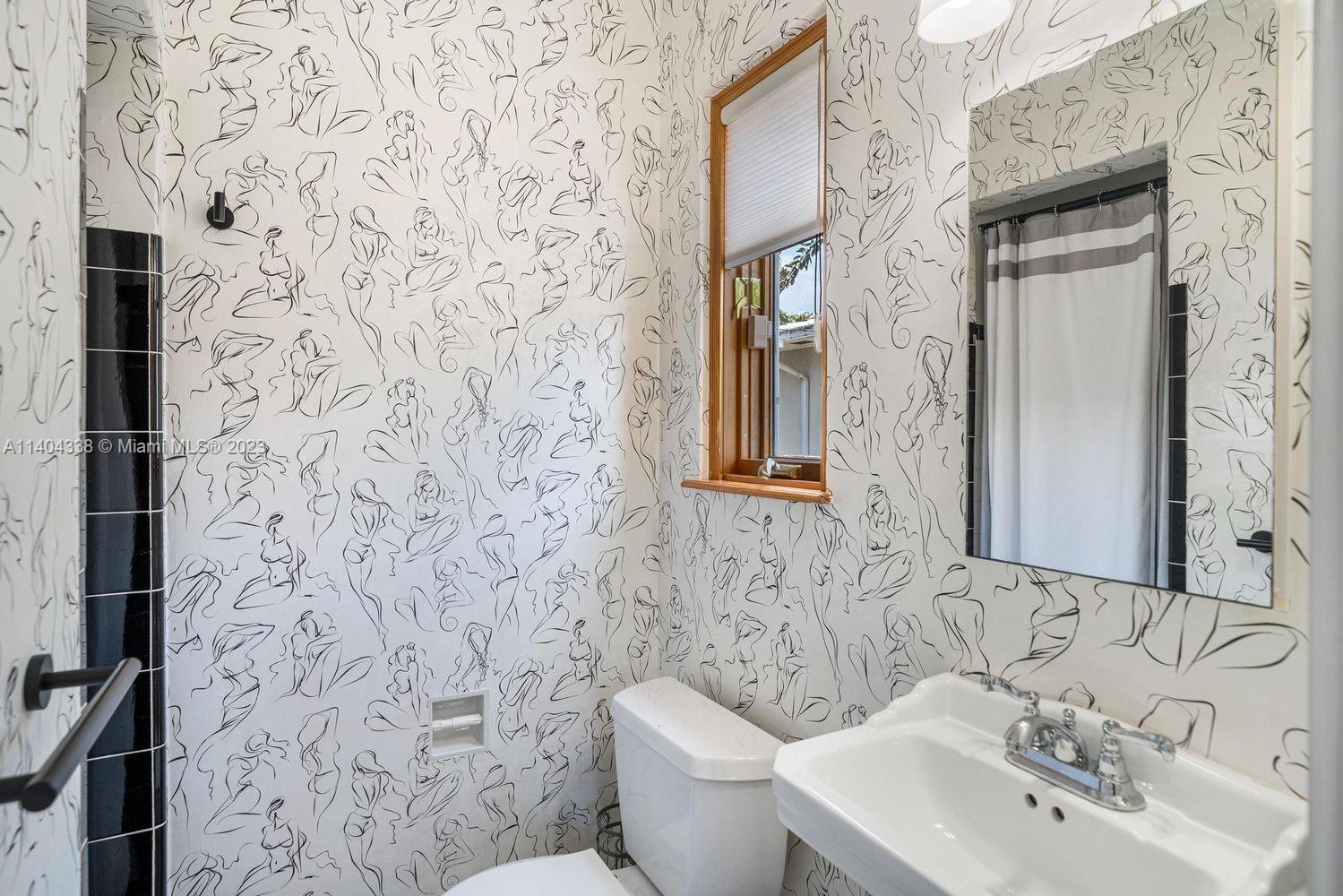 2500 Flamingo Drive Miami Beach, FL 33140 - Photo 14 of 27 a bathroom with a sink and mirror with toilet