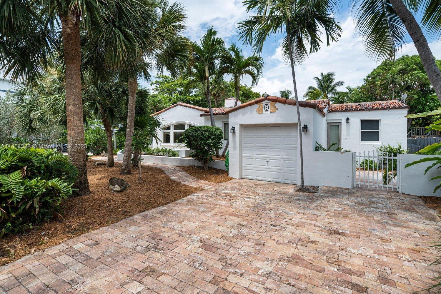 2500 Flamingo Drive Miami Beach, FL 33140 - Photo 2 of 27 a front view of a house with a yard and garage
