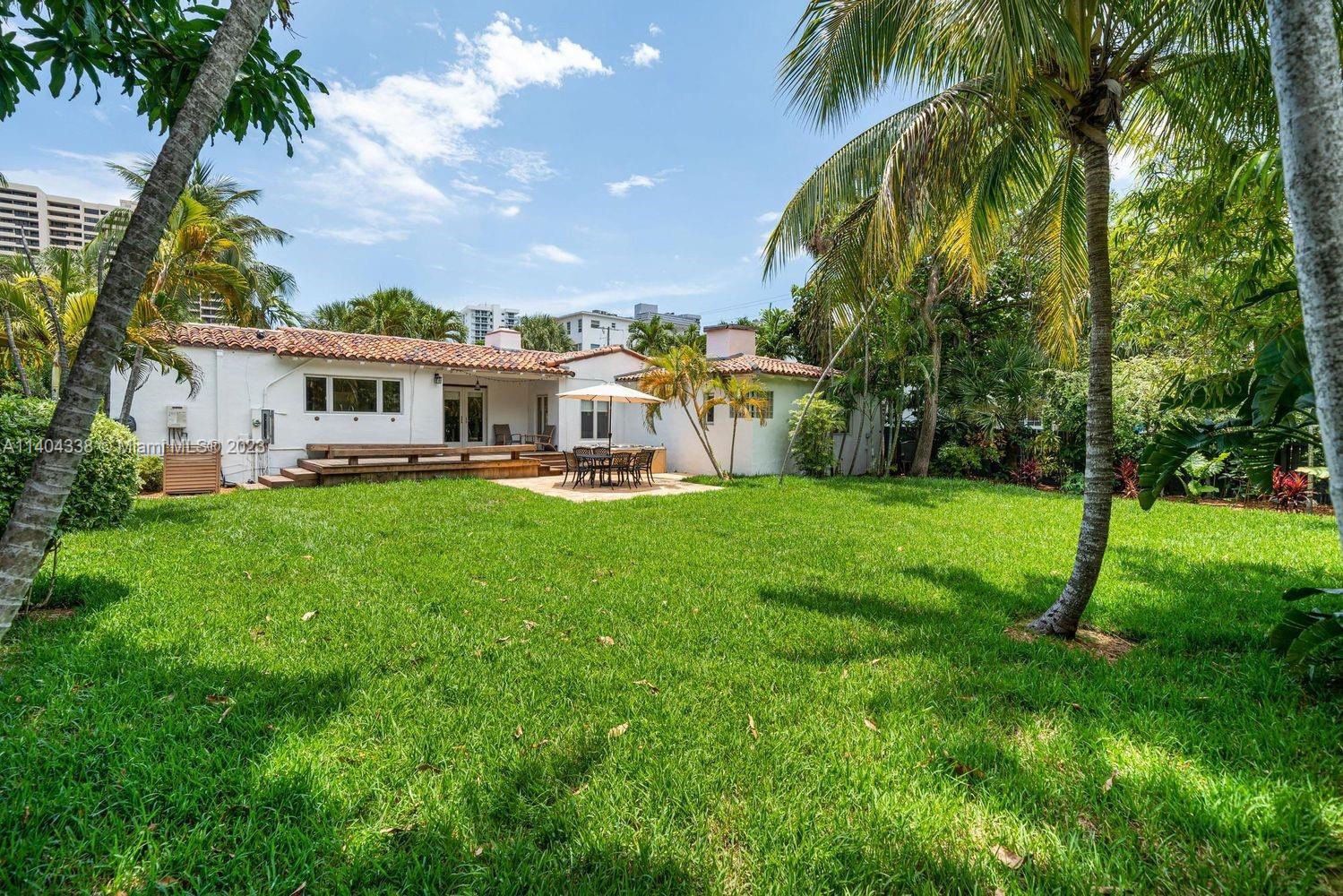 2500 Flamingo Drive Miami Beach, FL 33140 - Photo 23 of 27 a view of a house with a big yard and palm trees