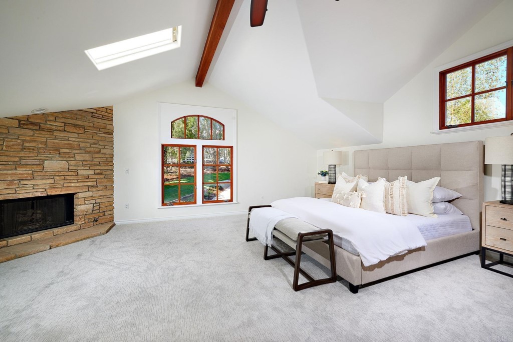 2931 Lone Jack Road Encinitas, CA 92024 - Photo 16 of 40 a spacious bedroom with a bed and a fireplace