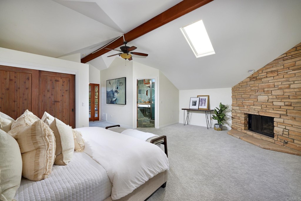 2931 Lone Jack Road Encinitas, CA 92024 - Photo 17 of 40 a bedroom with a bed and a fireplace