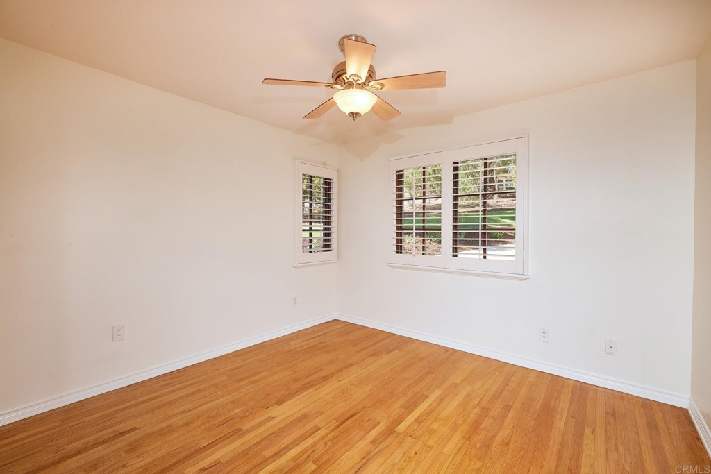 2931 Lone Jack Road Encinitas, CA 92024 - Photo 19 of 40 an empty room with wooden floor fan and windows