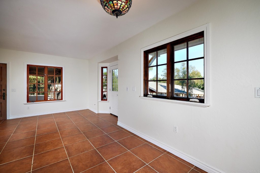 2931 Lone Jack Road Encinitas, CA 92024 - Photo 26 of 40 a view of an empty room with window and wooden floor