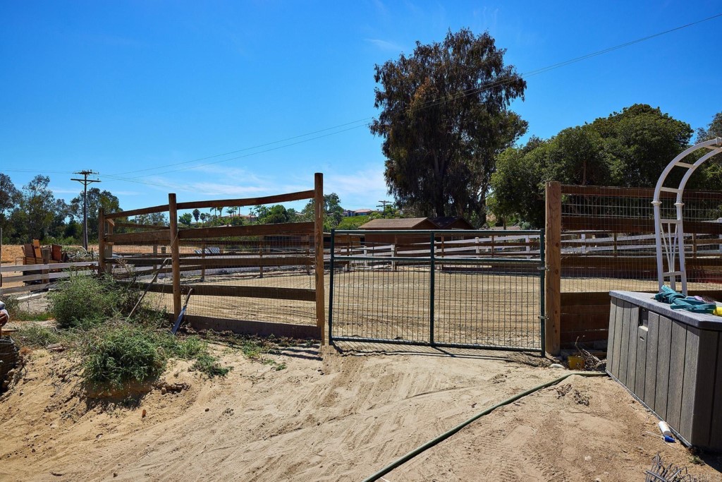 2931 Lone Jack Road Encinitas, CA 92024 - Photo 32 of 40 a view of a deck with a floor to ceiling window and wooden fence