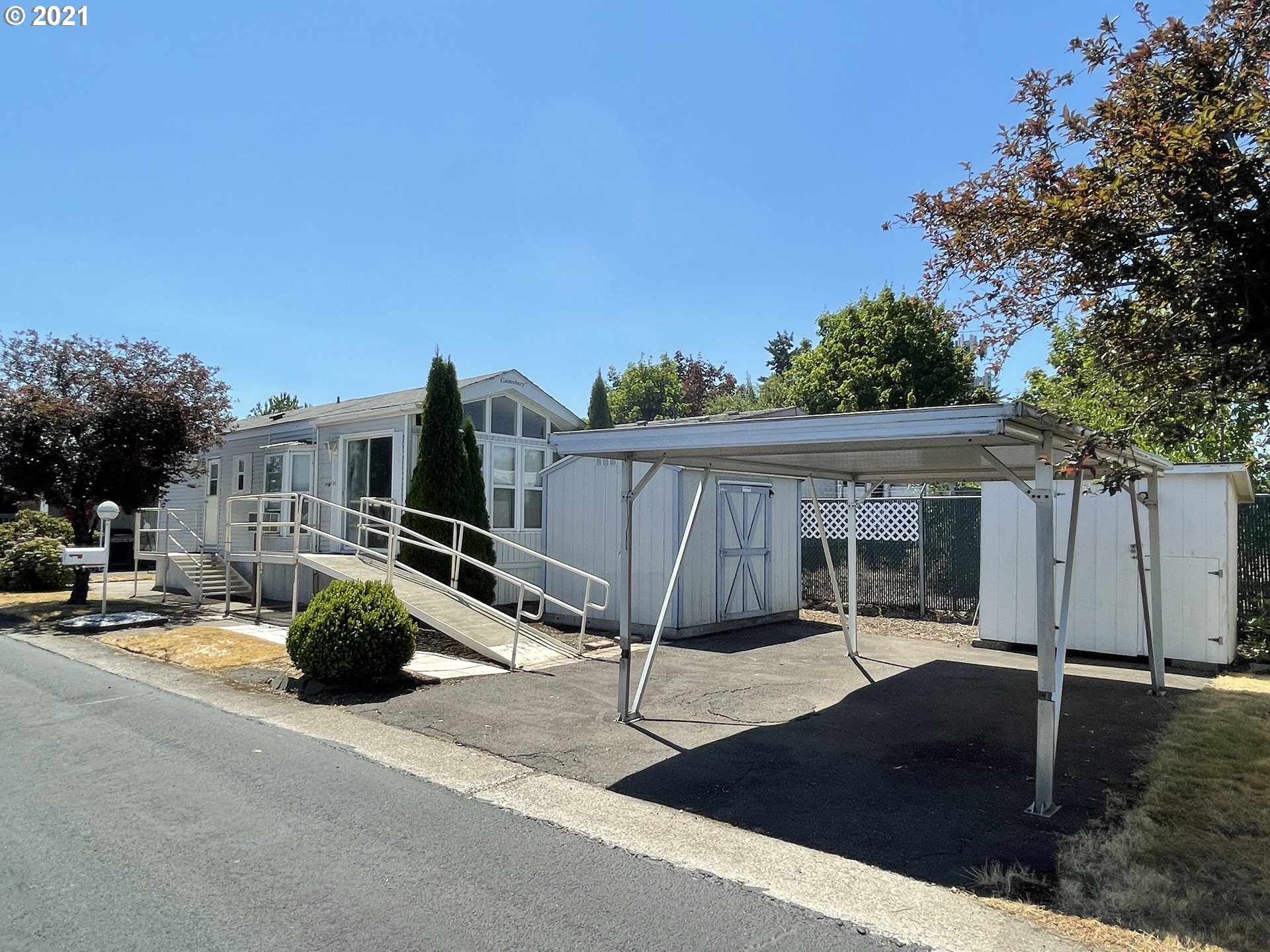 19776 Southeast Stark Street Portland, OR 97233 - Photo 15 of 18 a view of a patio with table and chairs a barbeque with wooden fence and plants